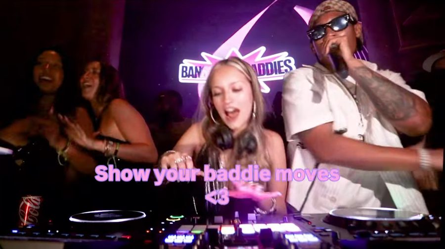 Female DJ on the decks under the Bangkok Baddies sign